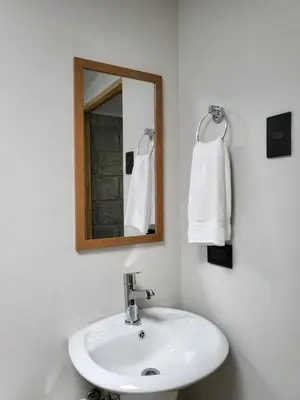a bathroom with a white sink and a mirror at Casa del Cafe-Familiar in Heredia