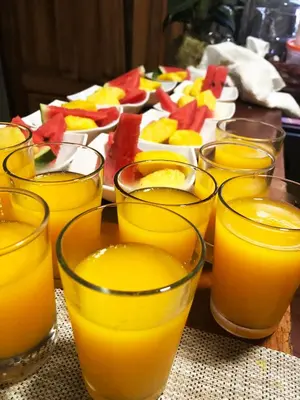 a group of glasses of orange juice on a table at Casa Jungle Monteverde B&B in Monteverde Costa Rica