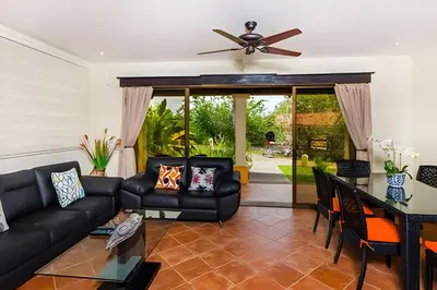 a living room with black furniture and a ceiling fan at Beautiful and comfortable Two Bedrooms Beach Condo in Coco