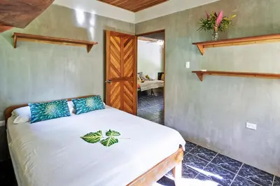 a bedroom with a bed in a room at Don Jon's Surf and Yoga Lodge in Santa Teresa Beach