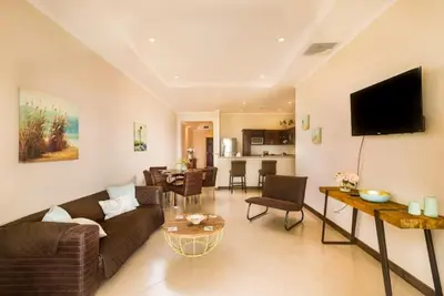 a living room with a couch and a table at Playa Flamingo, Stunning Sunset View Condominium Flamingo Towers 17 in Playa Flamingo