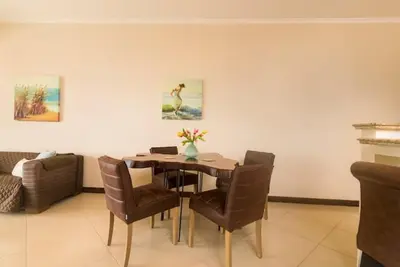 a dining room with a table and chairs at Playa Flamingo, Stunning Sunset View Condominium Flamingo Towers 17 in Playa Flamingo