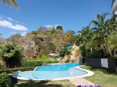 a swimming pool in the yard of a house at Playa Flamingo, Stunning Sunset View Condominium Flamingo Towers 17 in Playa Flamingo