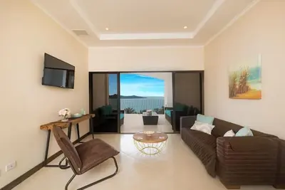 a living room with a couch and a table at Playa Flamingo, Stunning Sunset View Condominium Flamingo Towers 17 in Playa Flamingo