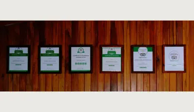 a row of signs hanging on a wooden wall at Cabañas Valle Campanas - Monteverde, Costa Rica in Monteverde Costa Rica