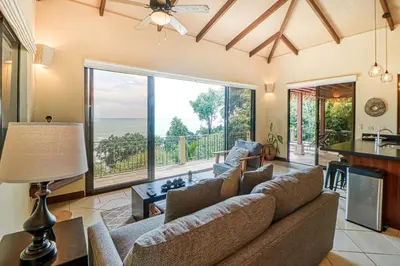 a living room with a couch and a view of the ocean at Canto del Mar #20 in Dominical