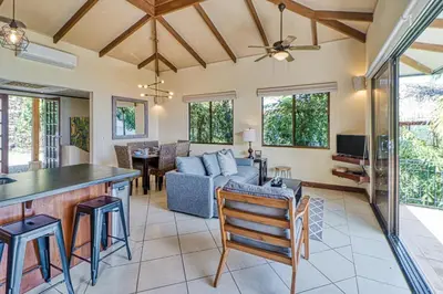 a kitchen and living room with a couch and a table at Canto del Mar #20 in Dominical