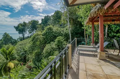 a balcony of a house with a view of the ocean at Canto del Mar #20 in Dominical