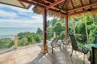a patio with chairs and a view of the ocean at Canto del Mar #20 in Dominical