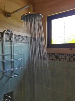 a shower in a bathroom with a shower curtain at Ocean Melody 2 in Uvita