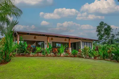 a house with a lawn in front of it at La Finca Lodge in Fortuna