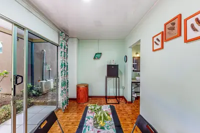 a living room with a table and a window at Nueva Villa Paraíso Four Villas in Lagunillas