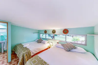 two beds in a room with blue walls and windows at Nueva Villa Paraíso Four Villas in Lagunillas