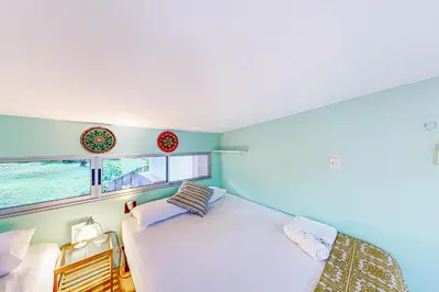 a bedroom with a white bed and a window at Nueva Villa Paraíso Four Villas in Lagunillas