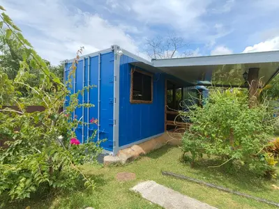 a blue tiny house in a yard at Arenal Homes La Fortuna in Fortuna