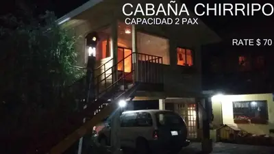 a car parked in front of a building at night at Hotel Chalets Los Volcanes in Alajuela City