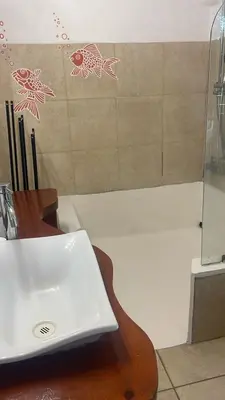 a laptop computer sitting on a table next to a shower at Casa Piscina in Santa Teresa Beach