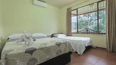 a bedroom with two beds and a stuffed elephant on the bed at Condo's Vista Al Volcan in Fortuna