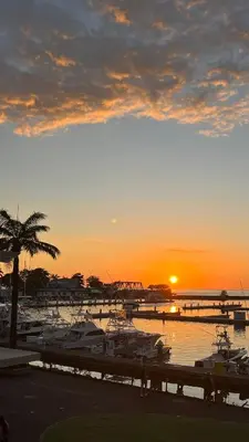 a sunset over a marina with boats in the water at Yellow House in Quepos