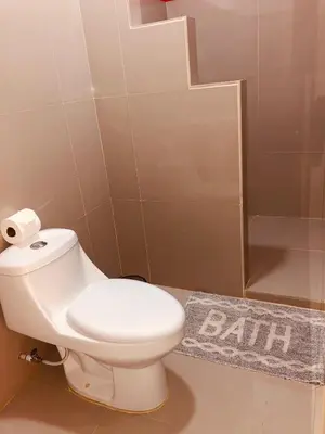 a bathroom with a white toilet and a mirror at Millenium Manuel Antonio Park and beach in Manuel Antonio