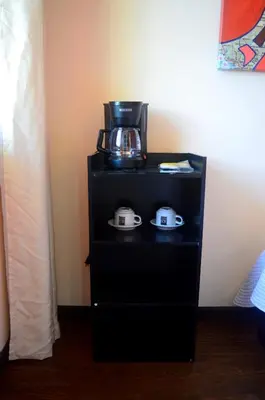 a black stand with a coffee maker on top of it at Millenium Manuel Antonio Park and beach in Manuel Antonio