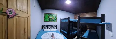 a bedroom with two bunk beds in a room at Hostel Tortuguero 7BackPackers in Tortuguero