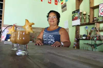 a woman sitting at a counter at a bar at Hostel Tortuguero 7BackPackers in Tortuguero