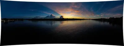 a sunset over a body of water with the sun setting at Hostel Tortuguero 7BackPackers in Tortuguero