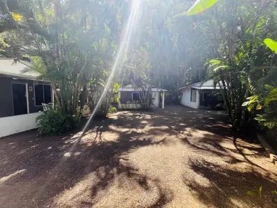 a house with the sun shining through the trees at Villas Majolana in Herradura