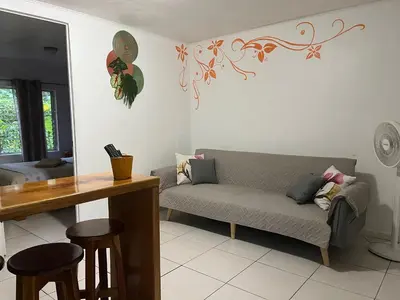 a living room with a couch and a table at Villas Majolana in Herradura