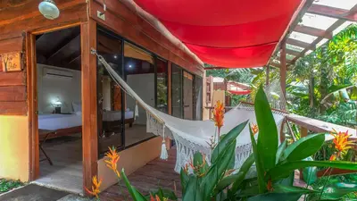 a hammock on the porch of a house at Boca Tapada Lodge in Boca Tapada