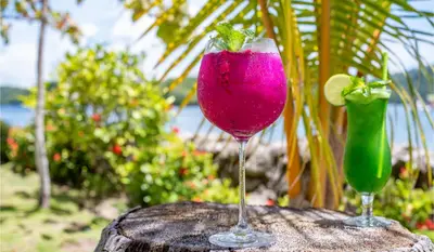 two cocktails sitting on top of a table at Isla Chiquita Glamping Hotel in Puntarenas