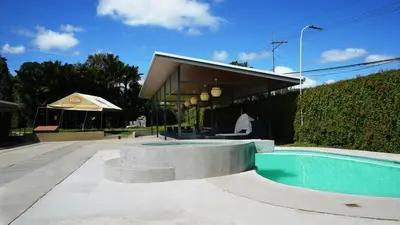 a house with a swimming pool next to a building at Hotel Pacuare in Siquirres