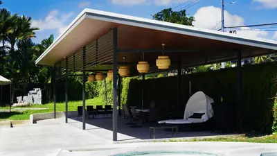 a pavilion with a table and chairs under it at Hotel Pacuare in Siquirres
