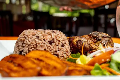 a plate of food on a table with food at Hotel Pacuare in Siquirres
