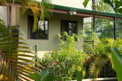 a house with a lot of plants in front of it at Villas Oasis in Manuel Antonio