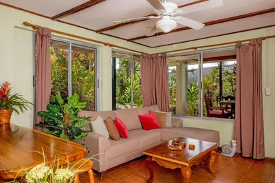 a living room with a couch and a table at Villas Oasis in Manuel Antonio