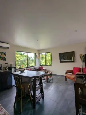 a living room with a table and a couch at Villas Oasis in Manuel Antonio
