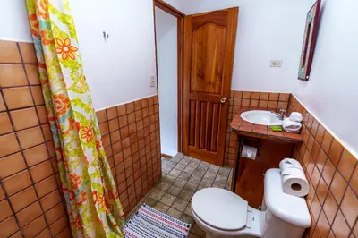 a bathroom with a toilet and a sink at Pension Santa Elena in Monteverde Costa Rica