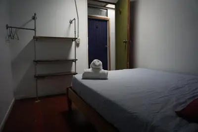 a bedroom with a bed with a stuffed animal on it at Pension Santa Elena in Monteverde Costa Rica