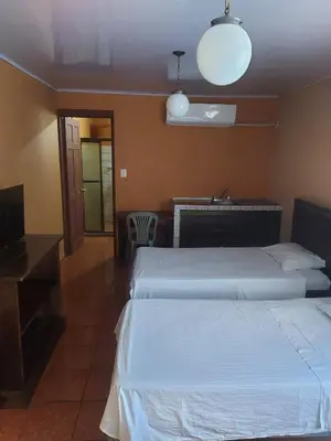 a hotel room with two beds and a television at Hotel Torre Fuerte in Venecia