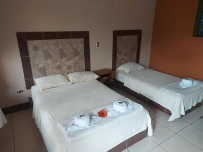 a hotel room with two beds with towels on them at Hotel Torre Fuerte in Venecia