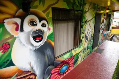 a mural of a monkey on the side of a building at La Terraza Guest House B&B in Grecia