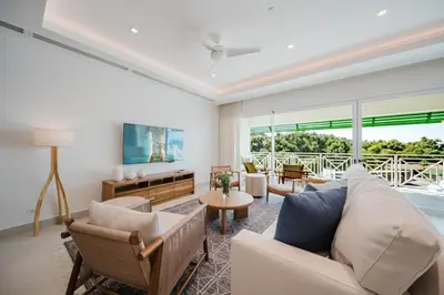 a living room with a couch and a table at Las Villas Marina Pez Vela in Quepos