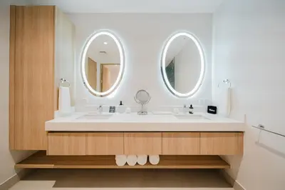 a bathroom with a sink and two mirrors at Las Villas Marina Pez Vela in Quepos