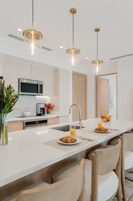 a kitchen with a counter with two plates of food on it at Las Villas Marina Pez Vela in Quepos