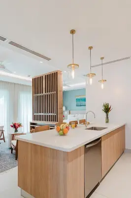 a kitchen with a island with a bowl of fruit on it at Las Villas Marina Pez Vela in Quepos