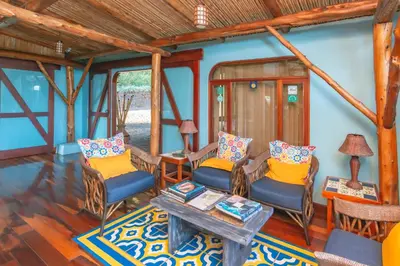a living room with chairs and a table at Finca Rosa Blanca Coffee Farm and Inn in Heredia