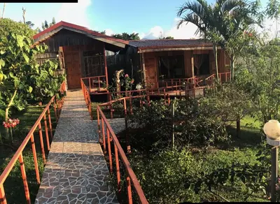a house with a pathway leading to it at Hotel Palenque Tarrazu in San Marcos