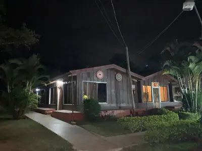 a house at night with lights on at Hotel Palenque Tarrazu in San Marcos